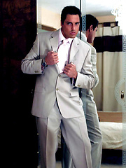 Hunky Marcello takes off his suit and plays with his huge cock - Gay porn pics at Gaystick