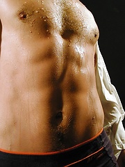 Ripped stud Ronny strokes his cock on the bed. - Gay porn pics at Gaystick